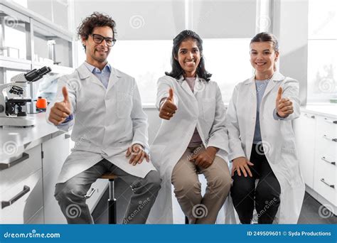 Happy Scientists Showing Thumbs Up In Laboratory Stock Image Image Of