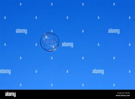 Soap Bubble Flying Against The Blue Sky Stock Photo Alamy