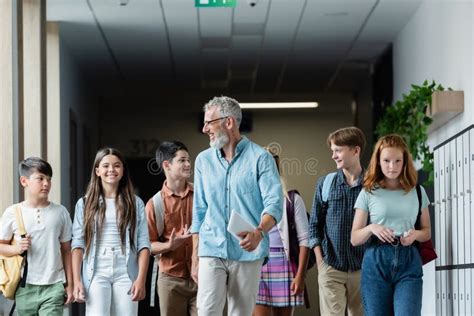 Teenage Boy Talking To Smiling Teacher Stock Image - Image of positive, pleased: 227679541