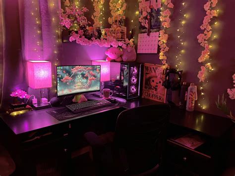 a computer desk topped with a desktop computer next to a purple wall ...