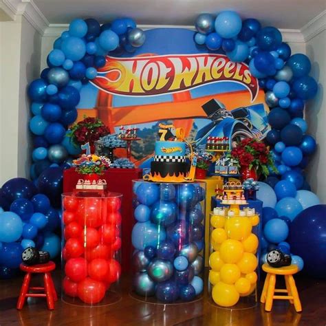 An Assortment Of Balloons And Decorations For A Hot Wheels Birthday Party