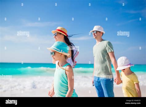 Happy beautiful family on white beach having fun Stock Photo - Alamy