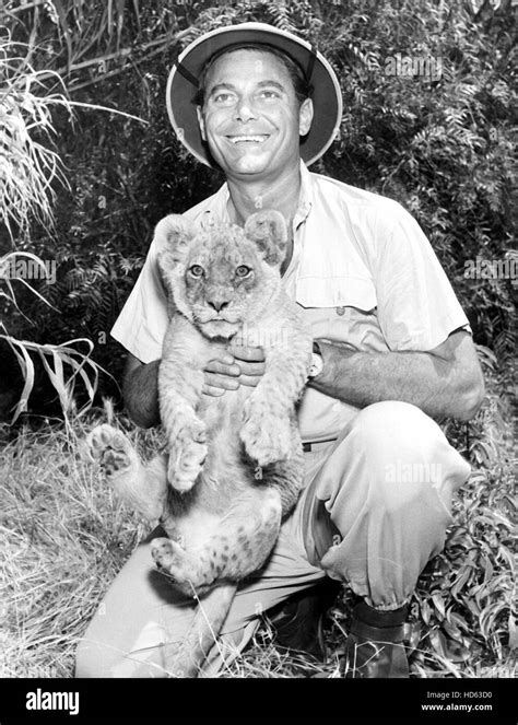 RAMAR OF THE JUNGLE, Jon Hall, holding a co-star, 1952-54 Stock Photo ...