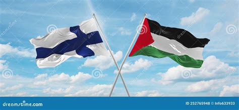 Two Crossed Flags Palestine And Finland Waving In Wind At Cloudy Sky