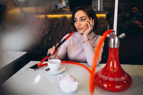 Premium Photo Woman Drinking Tea And Smoking Shisha