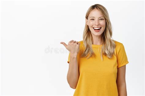 Portrait Of Happy Smiling Cute Girl Woman Pointing Finger Left At Copy