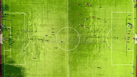 Aerial Top Down Shot of Football Players Training on the Green Soccer ...