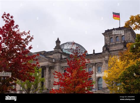 View Of The Reichstag In Autumn Colors With German Flag Mitte Berlin