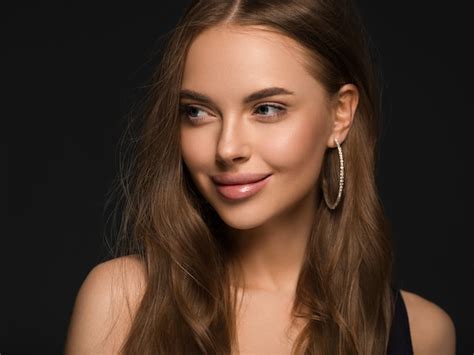 Premium Photo Beautiful Woman With Long Healthy Curly Brunette Hair Earrings Black Dress Black