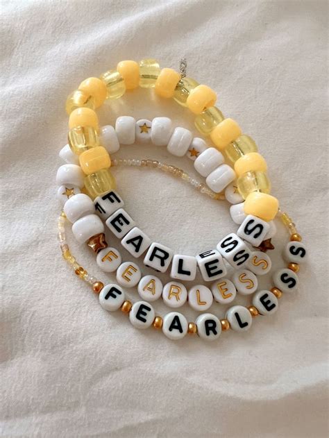 3 yellow and gold beaded bracelets saying fearless for Taylor swift ...