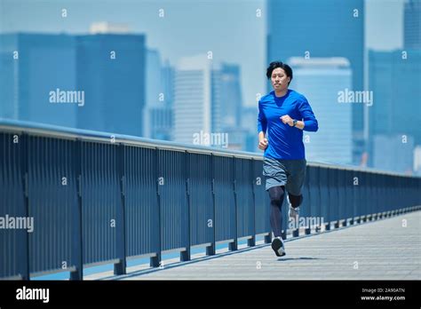 Young Japanese Man Running Downtown Tokyo Stock Photo Alamy