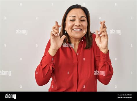 Hispanic Mature Woman Standing Over White Background Gesturing Finger