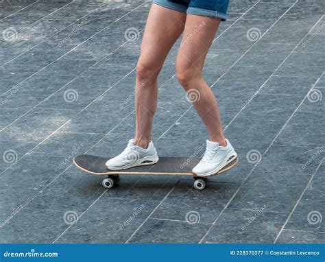 The Girl Rides A Skateboard Legs And Skateboard Close Up Stock Image