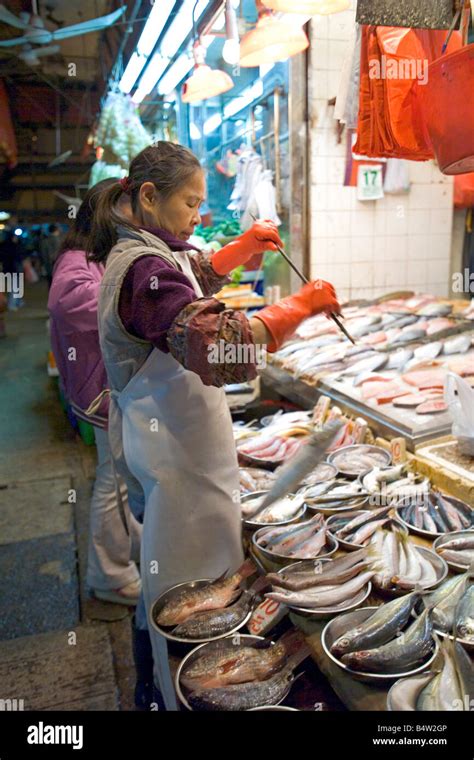 A Local Stall Shop Owner Weighing Fish At The Wan Chai Wet Market In