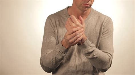 Close Up Of Man Massaging His Wrist On White Background Healthcare And