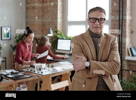 Smiling Mature Male Architect In Smart Casualwear And Eyeglasses