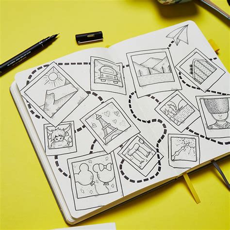 An Open Notebook With Pictures On It Next To Some Pens And Pencils