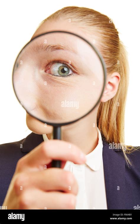 Business Woman Looking Suspicious With Her Eye Through A Magnifying