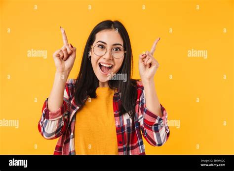Photo Of Excited Brunette Woman In Eyeglasses Smiling While Pointing
