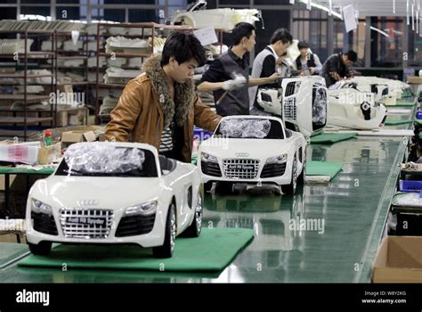 --FILE--Chinese workers assemble electric toy cars on the production line at a toy factory in ...