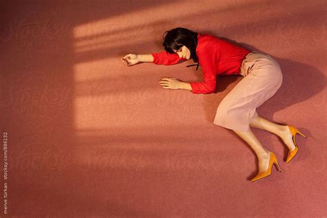 Woman Lying Down On The Floor Of A Room By Stocksy Contributor Ulas