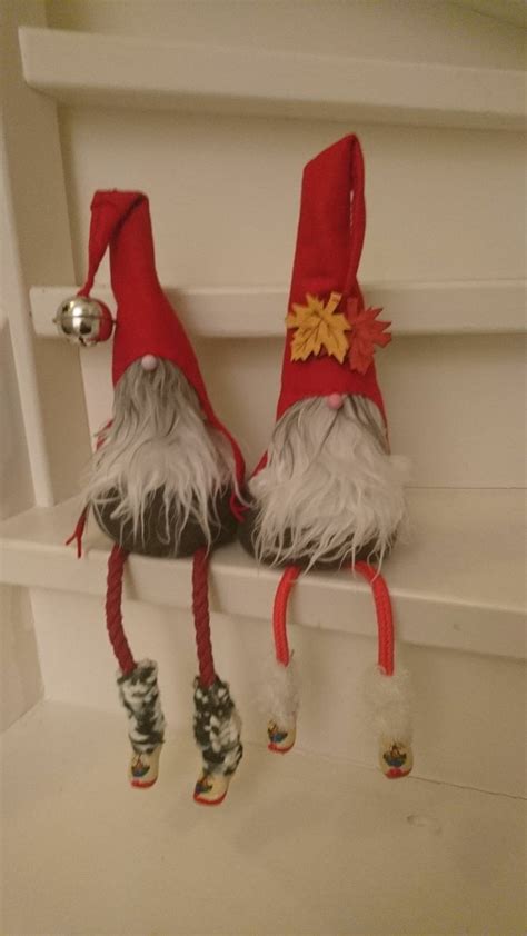 Two Red And White Gnome Hats Sitting On Top Of A Shelf