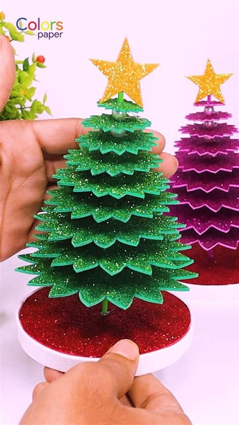 Someone Is Making A Christmas Tree Out Of Paper