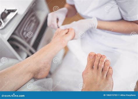 Pedicurist Doing Professional Medical Pedicure Procedure In Beauty