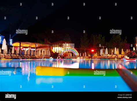 Swimming pool at a luxury resort at night time Stock Photo - Alamy