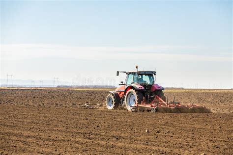 Farmer In Tractor Preparing Land With Seedbed Cultivator Stock Image