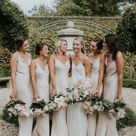 A Group Of Women Standing Next To Each Other In Front Of A Stone