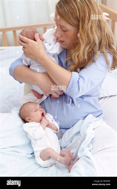 Mother And Two Week Old Twins Stock Photo Alamy