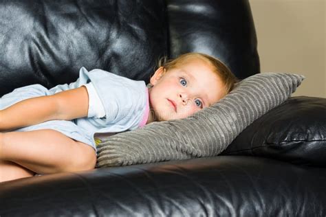 Child lying on the couch stock photo. Image of couch - 95635482