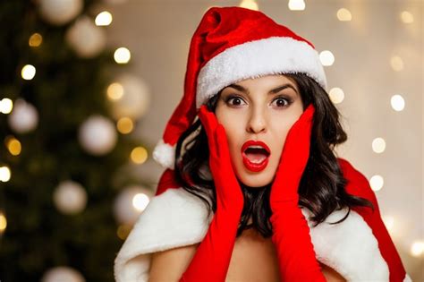 Premium Photo Beautiful Sexy Excited Girl Wearing Santa Claus Clothes On The Background Of The