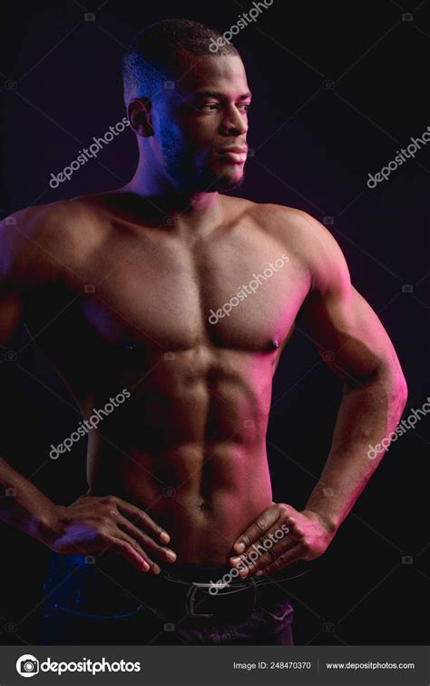 African Male Athlete With Naked Torso Posing Against Dark Wall Low Key