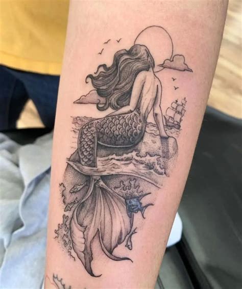 A Mermaid Tattoo On The Leg Of A Woman