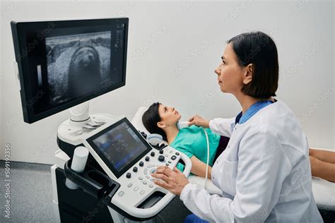 Endocrinologist making ultrasonography to female patient at ultrasound ...