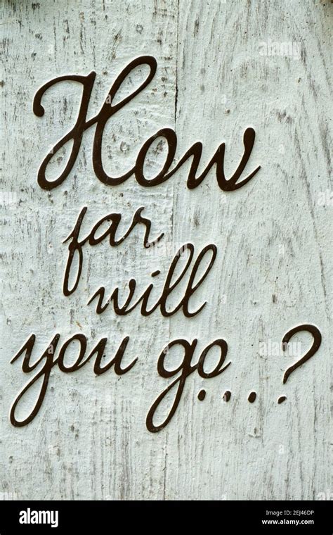 Rustic wooden sign with text: " how far will you go ?". Concept message ...
