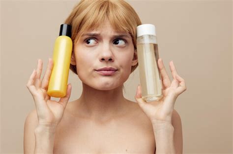 Premium Photo Midsection Of Woman Holding Bottle Against Pink Background