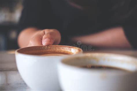 Two People Clink White Coffee Mugs On Wooden Table In Cafe Stock Image