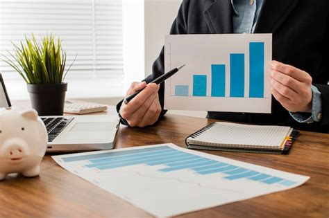 Free Photo Front View Of Businessman Holding Growth Chart