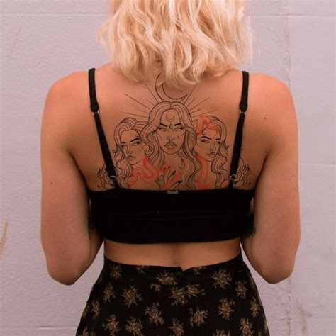 The Back Of A Woman S Body With Tattoos On Her Upper And Lower Back