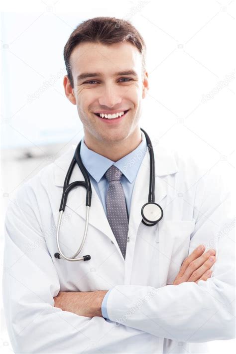 A Smiling Doctor With His Arms Crossed In Front Of Him