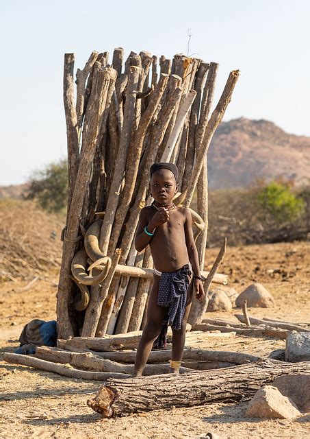 Mucubal Tribe Girl In Front Of A Totem With Cow Horns Namibe Province