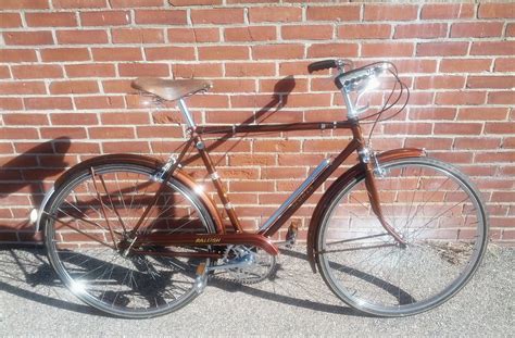 A Bicycle Parked Next To A Brick Wall