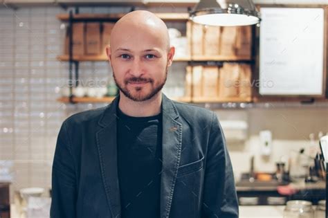 Portrait Of Attractive Adult Successful Bald Bearded Man In Suit On