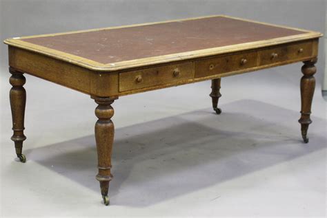 A Victorian Oak Library Table The Moulded Top Inset With A Brown