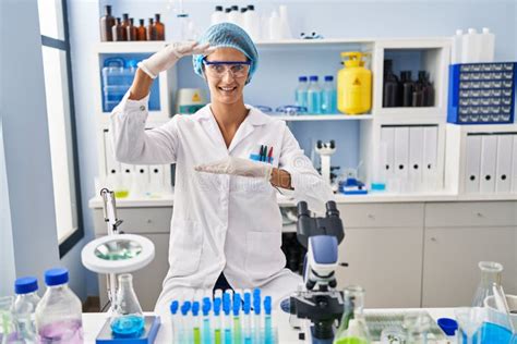 Brunette Woman Working At Scientist Laboratory Gesturing With Hands