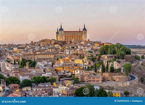 Sunset View Of Cityscape Of Toledo Dominated By Alcazar Castle Spain