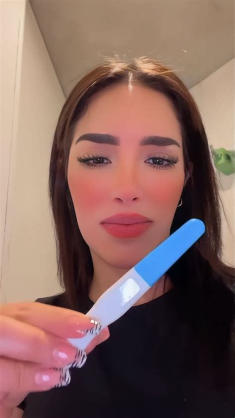 A Woman Holding A Toothbrush In Her Right Hand